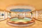 Swimming pool with a retractable glass roof