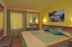 Relax in the colourful rooms of Iberostar Club Cala Barca