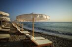 Sandy beach with umbrellas and sunbeds